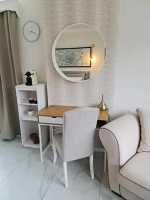 a room with a desk with a mirror and a couch at Lazy Olives in Tongeren