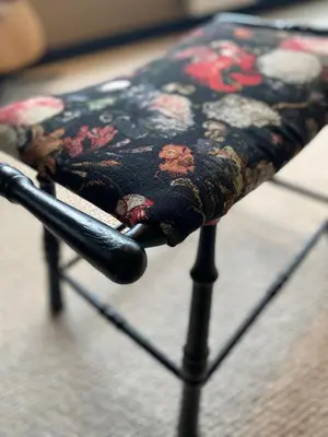 a black stool with a floral pattern on it at Spechthuisje, 4-pers bungalow in Rekem in Lanaken