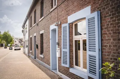 an open window on the side of a brick building at Maas Suites - The French House in Lanaken