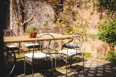 a couple of chairs sitting at a table at Maas Suites - The French House in Lanaken