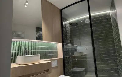 a bathroom with a sink and a glass shower at Vakantievilla Eetseveld in Bree