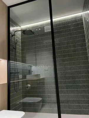 a bathroom with a glass shower and a toilet at Vakantievilla Eetseveld in Bree