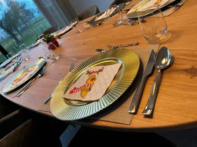 a table with a plate with a picture of a giraffe on it at Vakantievilla Eetseveld in Bree