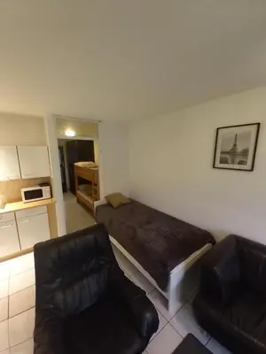 a living room with a bed and a couch at Ap5 Nature Ardennes Economy class apartment in La Calamine