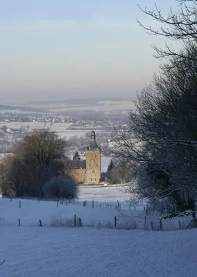 a building in a field in the snow at Appartement Hoeve Espewey - Leisure only in Hombourg