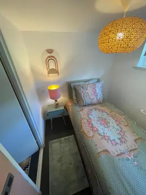a small bedroom with a bed and a lamp at Bungalow AMNIS by Sonnevijver Residences in Lanaken