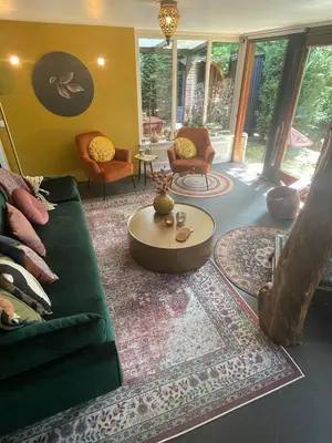 a living room with a green couch and a table at Bungalow AMNIS by Sonnevijver Residences in Lanaken