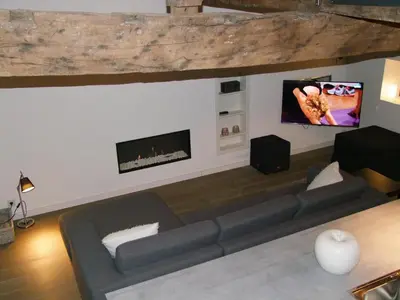 a living room with a couch and a flat screen tv at Holiday Home Janssen & Janssen in Maasmechelen