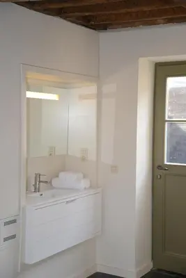 a bathroom with a sink and a mirror at Holiday Home Janssen & Janssen in Maasmechelen
