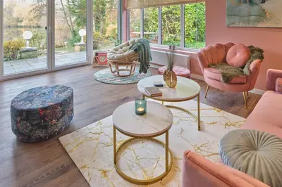 a living room with pink and gold furniture at Lacuna STILLA by Sonnevijver Residences in Lanaken
