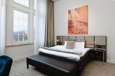 a hotel room with a bed and a window at Terhills Hotel in Maasmechelen