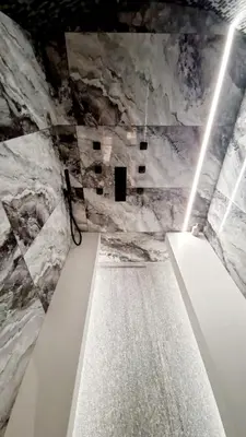 a walkway in a room with a marble wall at SuiteDreams - Bali Suite Liège in Liège