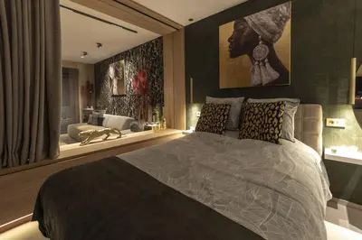 a bedroom with a large bed and a bathroom at SuiteDreams - Bali Suite Liège in Liège