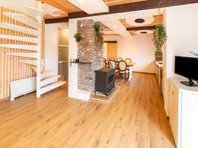 a living room with a fireplace and wooden floors at Charming Family Home in Esneux in Esneux