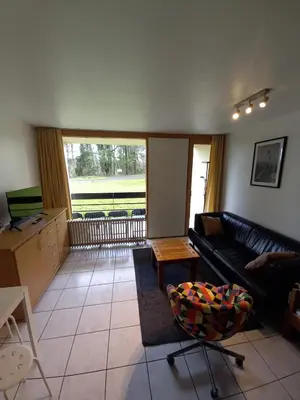a living room with a couch and a table at Ap4 Nature Ardennes Economy class apartment in La Calamine