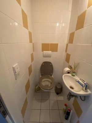 a small bathroom with a toilet and a sink at Zwaan7, Top Locatie! Top Deal! in Rekem