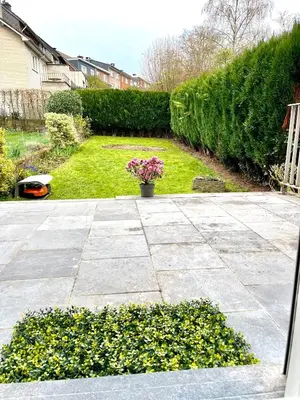 a garden with a potted plant on a patio at Happiness at Lili in Verviers
