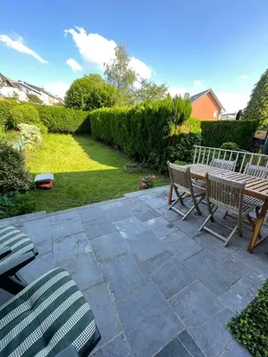 a patio with two chairs and a wooden table at Happiness at Lili in Verviers
