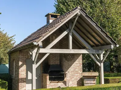 a large brick oven in a brick building at Charming Group Stay in Borgloon in Borgloon