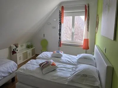 a bedroom with two beds and a window at Charming Group Stay in Borgloon in Borgloon
