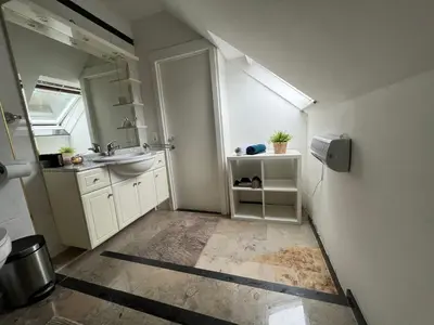 a small bathroom with a sink and a mirror at Maison Isa in Lommel