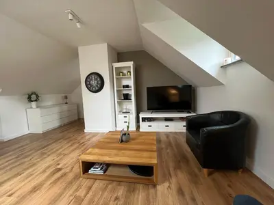 a living room with a couch and a coffee table at Maison Isa in Lommel