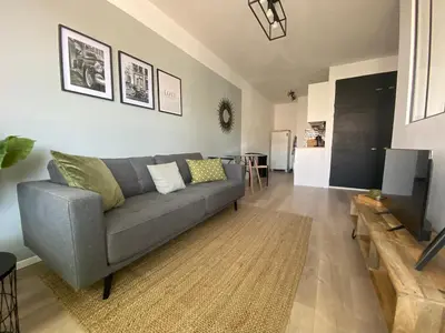 a living room with a gray couch and a table at 