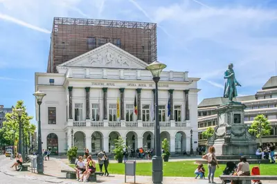 a large white building with a statue in front of it at 