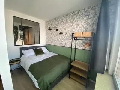 a small bedroom with a bed and a mirror at 
