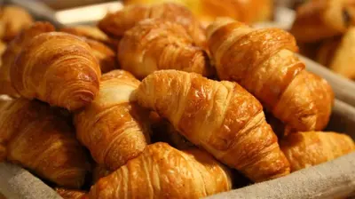 a pile of croissants sitting on top of a table at Lafarques in Pepinster