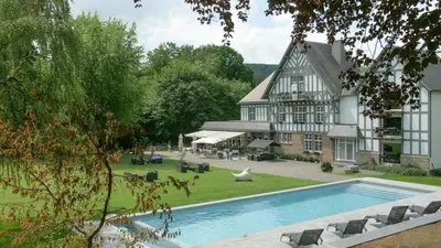an external view of a house with a swimming pool at Lafarques in Pepinster
