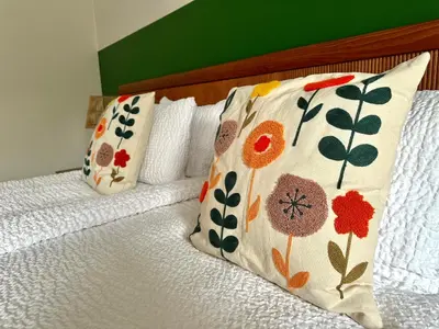 a bed with two pillows on top of it at Guesthouse De Wissen in Dilsen-Stokkem