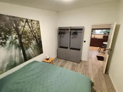 a bedroom with a bed and a large painting on the wall at Gusta in Maasmechelen