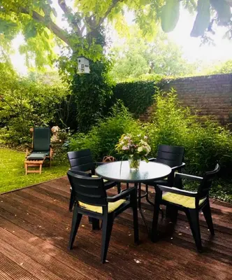 a table and chairs sitting on a wooden deck at Gusta in Maasmechelen