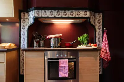 a kitchen with an oven with a counter top at Le Dragon Limbourg - Luxurious & Cozy Holiday Home in Limbourg