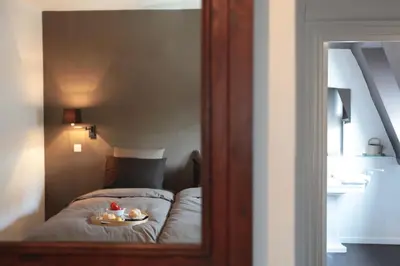 a bedroom with a bed with a plate of food on it at Le Dragon Limbourg - Luxurious & Cozy Holiday Home in Limbourg