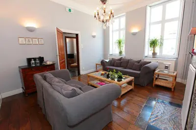 a living room with two couches and a table at Le Dragon Limbourg - Luxurious & Cozy Holiday Home in Limbourg