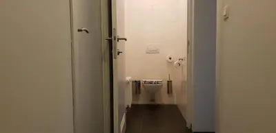 a small bathroom with a toilet in a stall at Apartment Campinor in Pelt