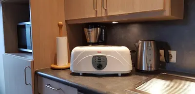 a white toaster sitting on a counter in a kitchen at Apartment Campinor in Pelt