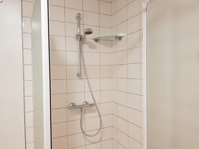 a shower with a shower head in a bathroom at Apartment Campinor in Pelt