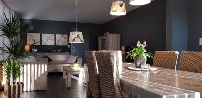 a living room with a table and some chairs at Apartment Campinor in Pelt