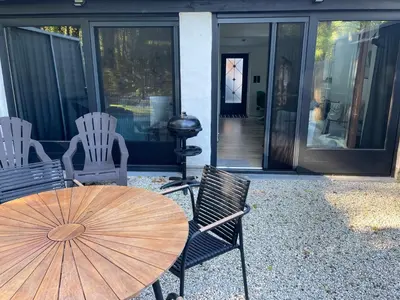 a patio with a table and chairs and a grill at Bokrijklodge in Hasselt