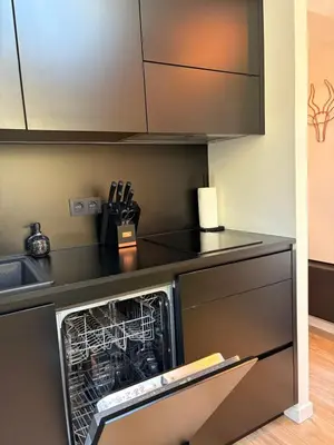 a kitchen with a dishwasher and a counter top at Bokrijklodge in Hasselt