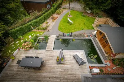 an aerial view of a backyard with a pool and tables and chairs at Gîte La Vieille Ferme Chaudfontaine et son jacuzzi in Chaudfontaine