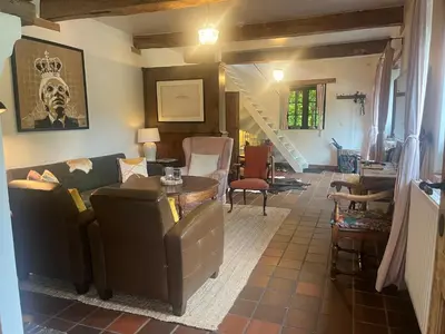 a living room with a couch and a table at Vakantiehuis Eksel in Hechtel-Eksel
