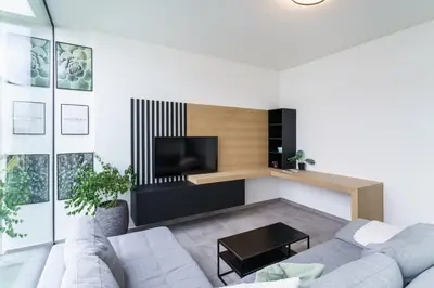 a living room with a couch and a tv at Nr 28 TravelHome in Heusden - Zolder