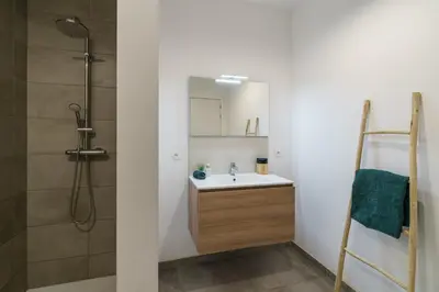 a bathroom with a sink and a shower at Nr 28 TravelHome in Heusden - Zolder