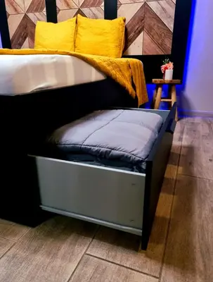 a bed with yellow pillows on top of it at Aslyra 
