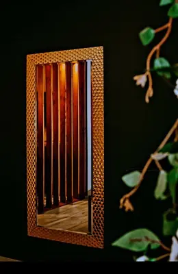 a mirror hanging on a wall with a fence at Aslyra 