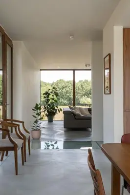 a living room with a couch and a table and chairs at Sweet Valley View - Architectenwoning in Zutendaal